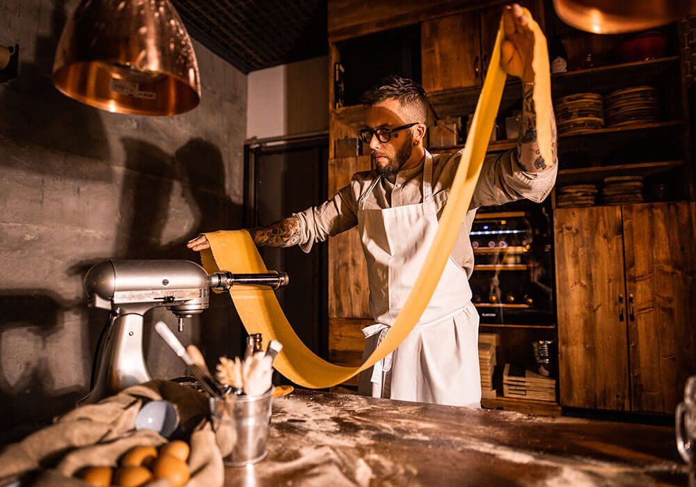 Pasta wird von Koch zum Schneiden vorbereitet.